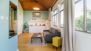 A modern living room with a sofa, coffee table, and a yellow cabinet.