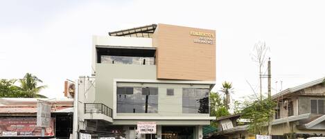 A two-story building with a sign for Edilberto's Bed and Breakfast.