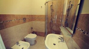 A bathroom with two sinks, a toilet, and a glass-enclosed shower. - Guesthouse San Domenico (Augusta)