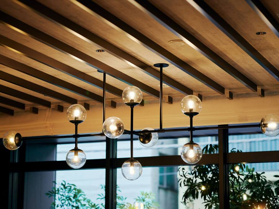 A modern interior with a wooden ceiling and large windows.