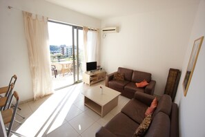 Apartment, 1 Bedroom | Living area | Flat-screen TV, DVD player