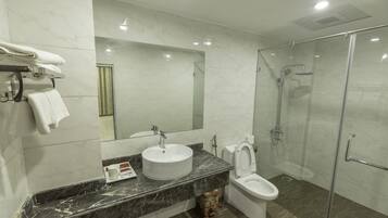 Shower, designer toiletries, hair dryer, slippers