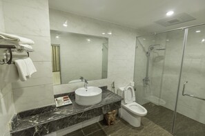 Shower, designer toiletries, hair dryer, slippers