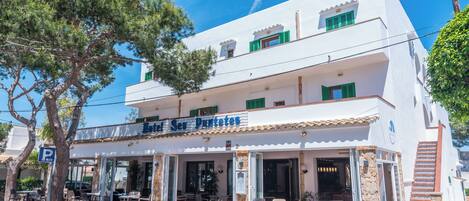 A two-story building with a restaurant named "Hotel Ses Puntes" on the ground floor.