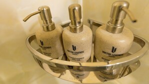 Three bottles of conditioner in a metal tray. - Viktor Legends Hotel (Mong Cai)