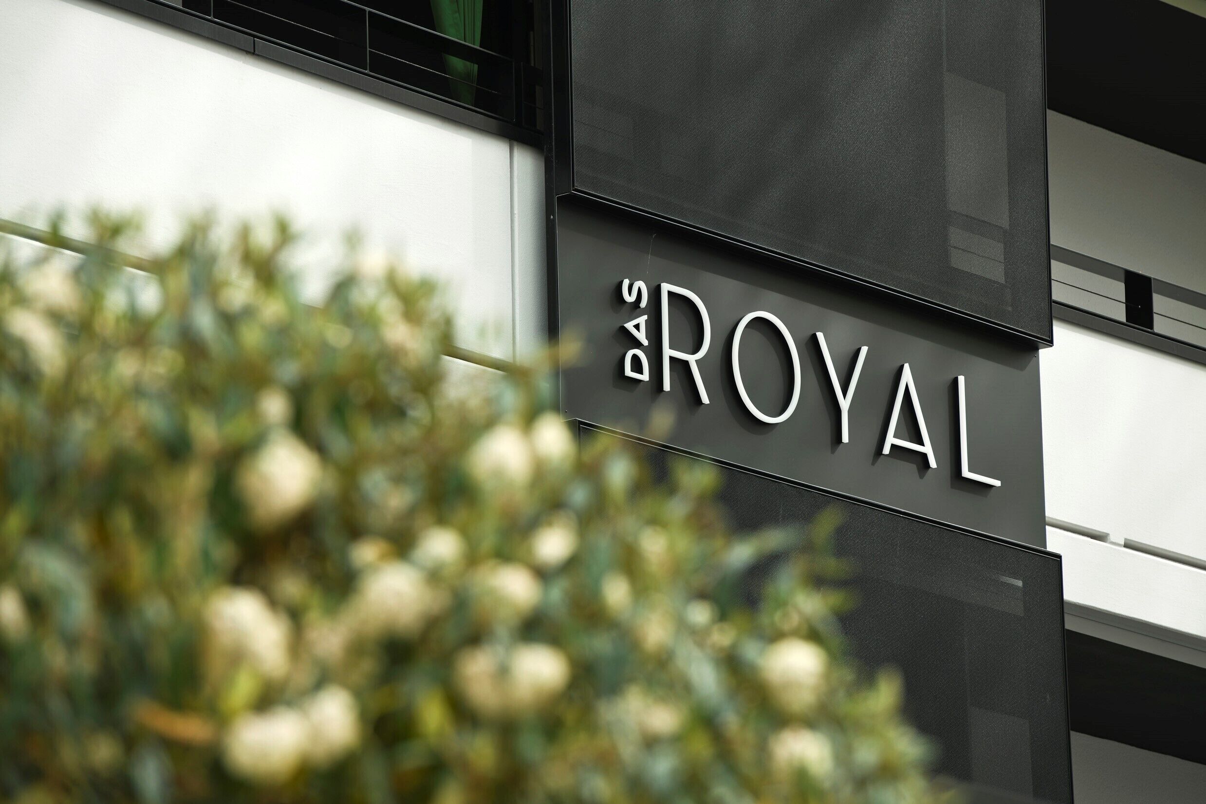 A building facade with the text "DAS ROYAL" indicating a hotel or property name.