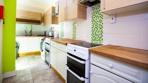 A kitchen with white cabinets, a wooden countertop, and a tiled backsplash. - 6 Bedrooms House NOT FAR from Central London, ECEL LONDON, CANARY WHARF O2 (Barking)