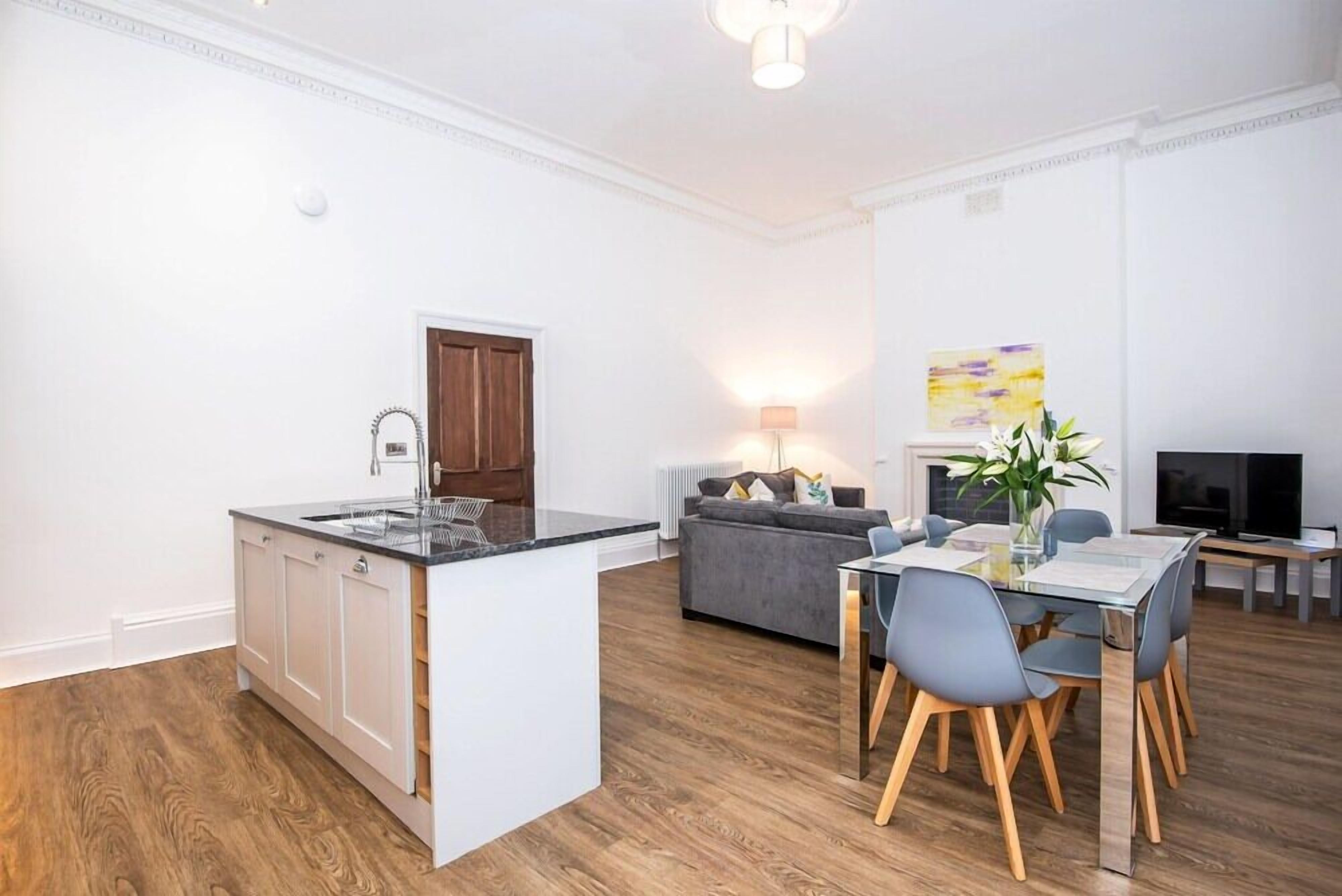 Un apartamento moderno con cocina, comedor y sala de estar.