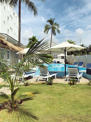 Outdoor pool, open 7:30 AM to 8:30 AM, pool umbrellas
