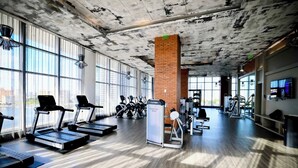 A gym with treadmills, exercise bikes, and weight machines.