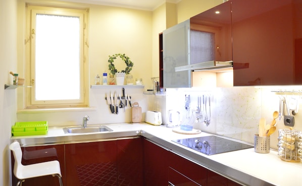 Prepare meals in this well-equipped kitchen with a stove and sink.