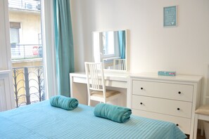 A bedroom with a bed, a desk, a chair, and a dresser. - Bajcsy 2 Apartment (Budapest)