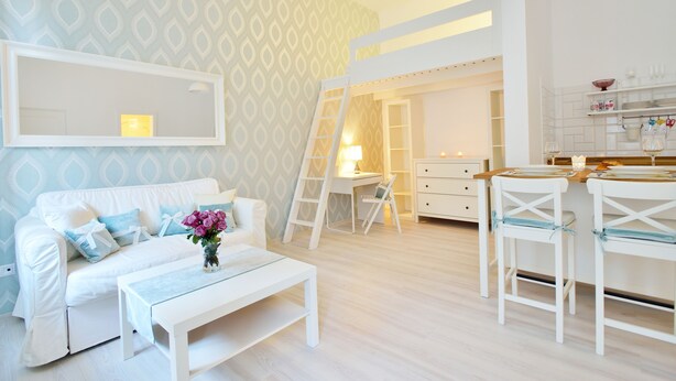 A modern living room with a sofa, coffee table, and a desk with a chair. - Dob 11 Apartment I. (Budapest)