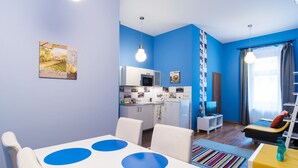 A compact living space with a dining area, kitchenette, and a bed. - Paulay 7 Apartment I. (Budapest)