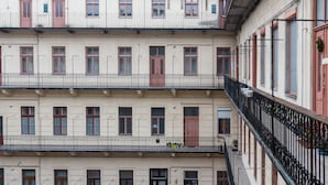 A multi-story building with balconies, windows, and doors. - Paulay 7 Apartment I. (Budapest)