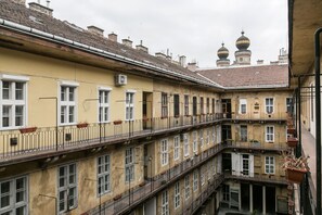 A multi-story building with balconies, large windows, and a traditional architectural style. - Rakoczi 6 Apartment (Budapest)