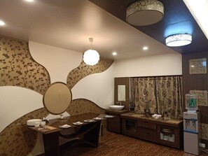 A bathroom with a vanity, sink, mirror, and a water dispenser. - Havelock Leisure (Ootacamund)