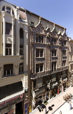 A multi-story building with ornate architectural details, including decorative moldings and a series of windows. - Vaci 12 Apartment (Budapest)