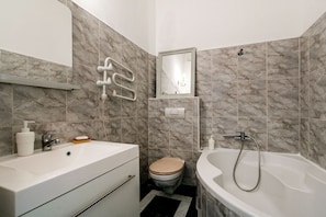 A bathroom with a sink, toilet, and bathtub.