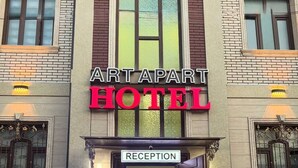 The Artapart Hotel entrance with a reception sign, a sign for the Meros Hotel, and a staircase leading inside. - Art Apart Hotel (Tashkent)