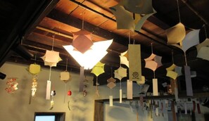 Experience the charm of this traditional room, featuring a unique ceiling with hanging paper lanterns and a window for natural light.