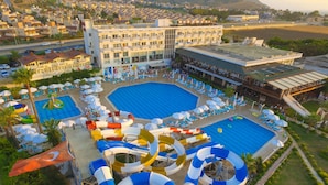 A resort with multiple swimming pools, water slides, and sun loungers.