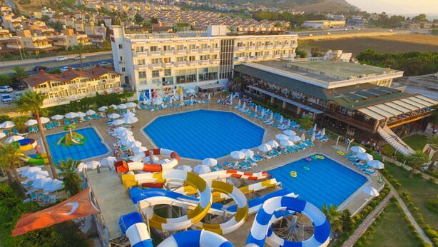 A resort with multiple swimming pools, water slides, and sun loungers.