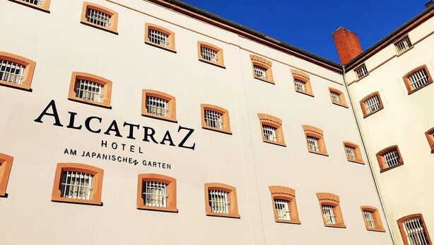 The exterior of the Alcatraz Hotel with multiple windows and a clear blue sky. - Alcatraz am Japanischen Garten (Kaiserslautern)