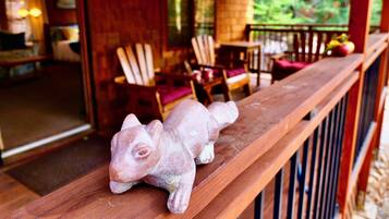 A rustic wooden bench with a decorative animal figure.