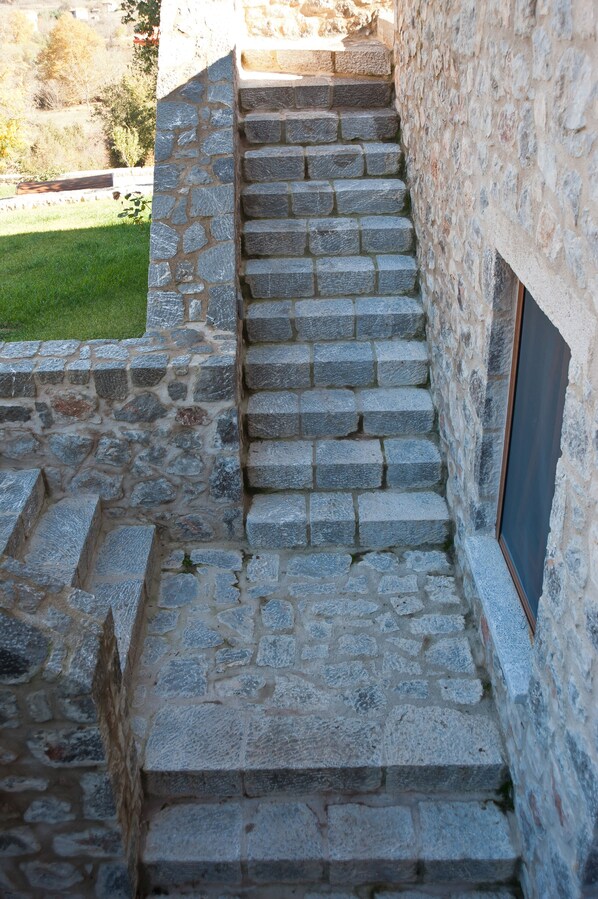 A stone staircase leading to a building with a window on the right. - Lilea Chalet (Delphi)