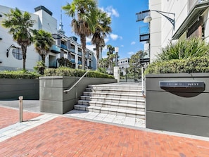A set of outdoor stairs leading to a building entrance with a sign reading 'Lafayette 37 West'.