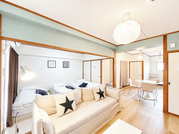Una habitación de hotel moderna con sofá, escritorio y zona de comedor.