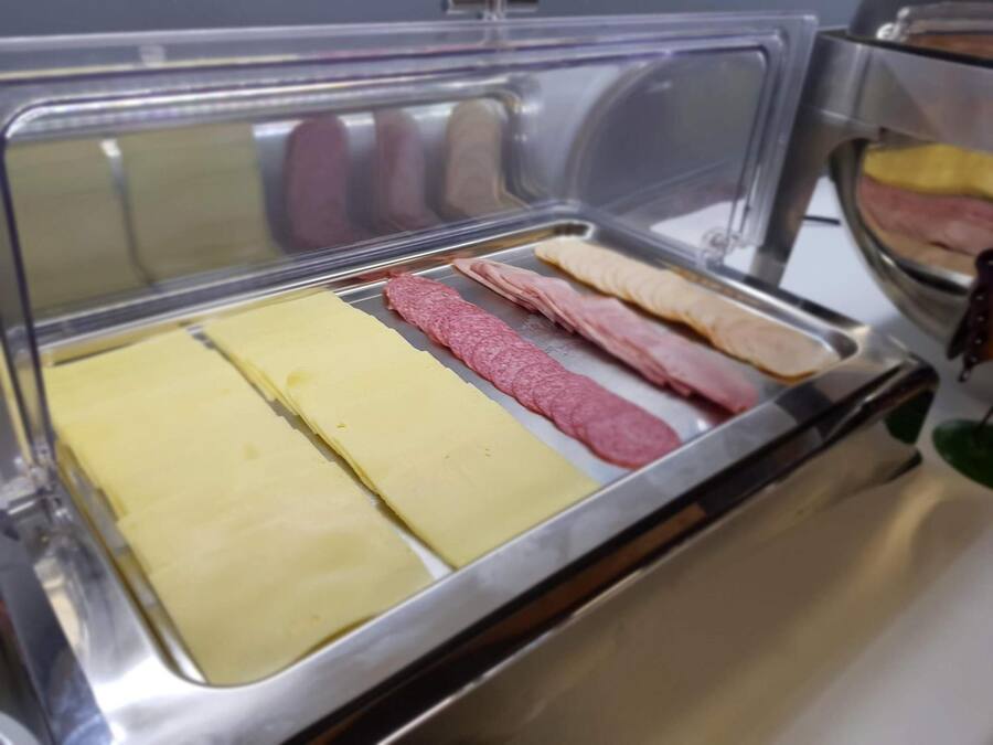 A deli display with various types of deli meats and cheeses.