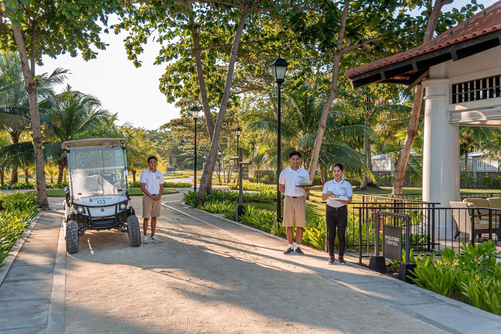A golf cart, a pathway, and a building with a sign that reads 'WELCOME CENTER'.