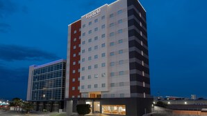 A multi-story hotel with a prominent "Fairfield by Marriott" sign, large windows, and a well-lit entrance area. - Fairfield by Marriott® Inn & Suites San Luis Potosi (San Luis Potosi)