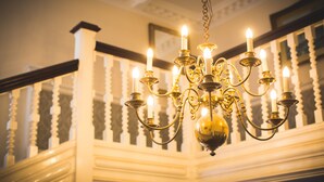 A chandelier with multiple candle-like lights hanging from a chain. - A beautiful home set in 11 acres of grounds, overlooking the Mendip Hills. (bristol)