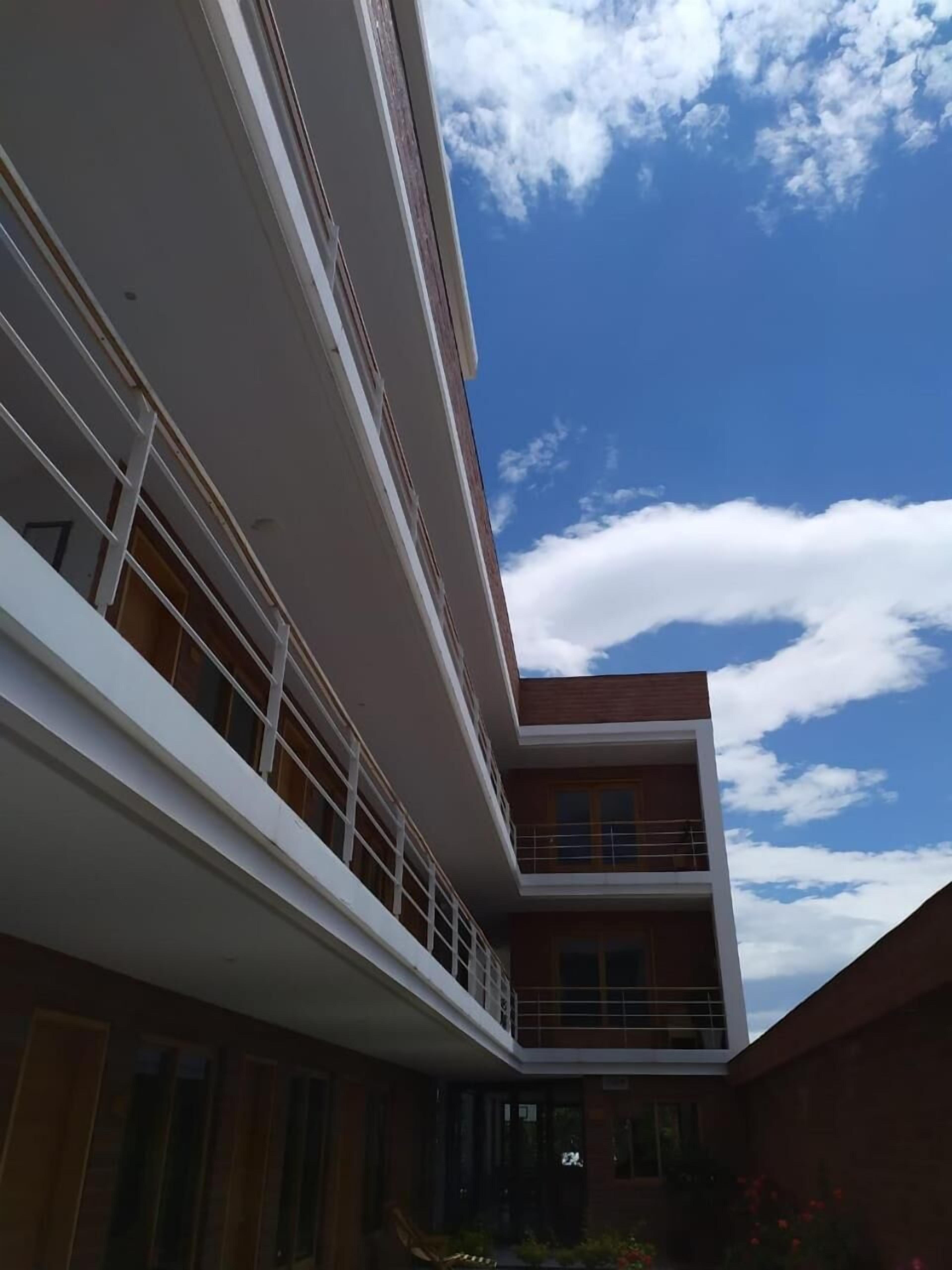A multi-story building with a balcony on the second floor.