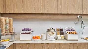 A breakfast buffet with various food items and containers.