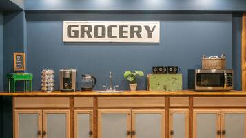 A kitchen counter with a sign that reads "GROCERY" above it.
