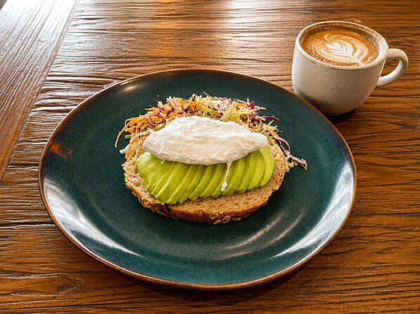 A plate with a sandwich, a cup of coffee, and a wooden table. - qema Lima (Lima)