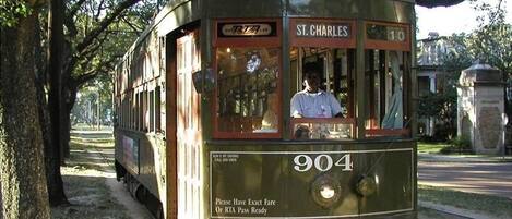 A vintage trolley with a sign reading "ST. CHARLES" and route number "904" parked on tracks.