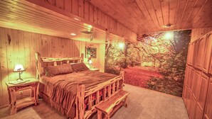 A wooden bedroom with a bed, nightstands, and a bench. - Storybook Mt Lemmon Log Cabin (Mt Lemmon)
