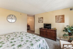 A bedroom with a bed, dresser, television, and wall art. - XPLORIE ACTIVITIES & LINENS INCLUDED*! 3BR/2BA Capri. Spectacular Bay View! (Ocean City)