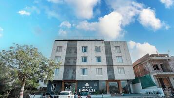 A multi-story building with a storefront labeled "The White Fresco."