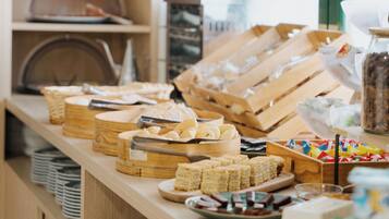 A buffet setup with various food items and containers.