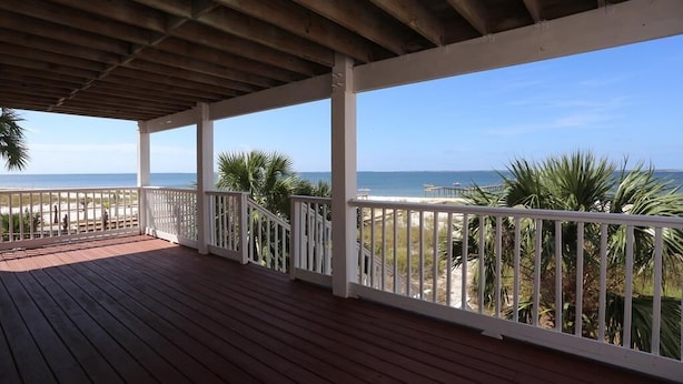 A wooden deck with white railings overlooking a beach and ocean. - Beachfront, Private, No Frills ~ Amethyst Cove (St. Joe Beach)
