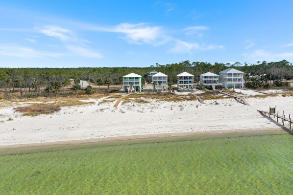 A beachfront property with multiple houses connected by walkways.