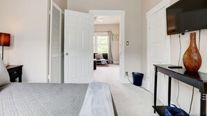 A bedroom with a bed, a desk, a TV, and a large window. - Your own historic estate in the heart of Old Louisville! NEAR IT All!! (Louisville)