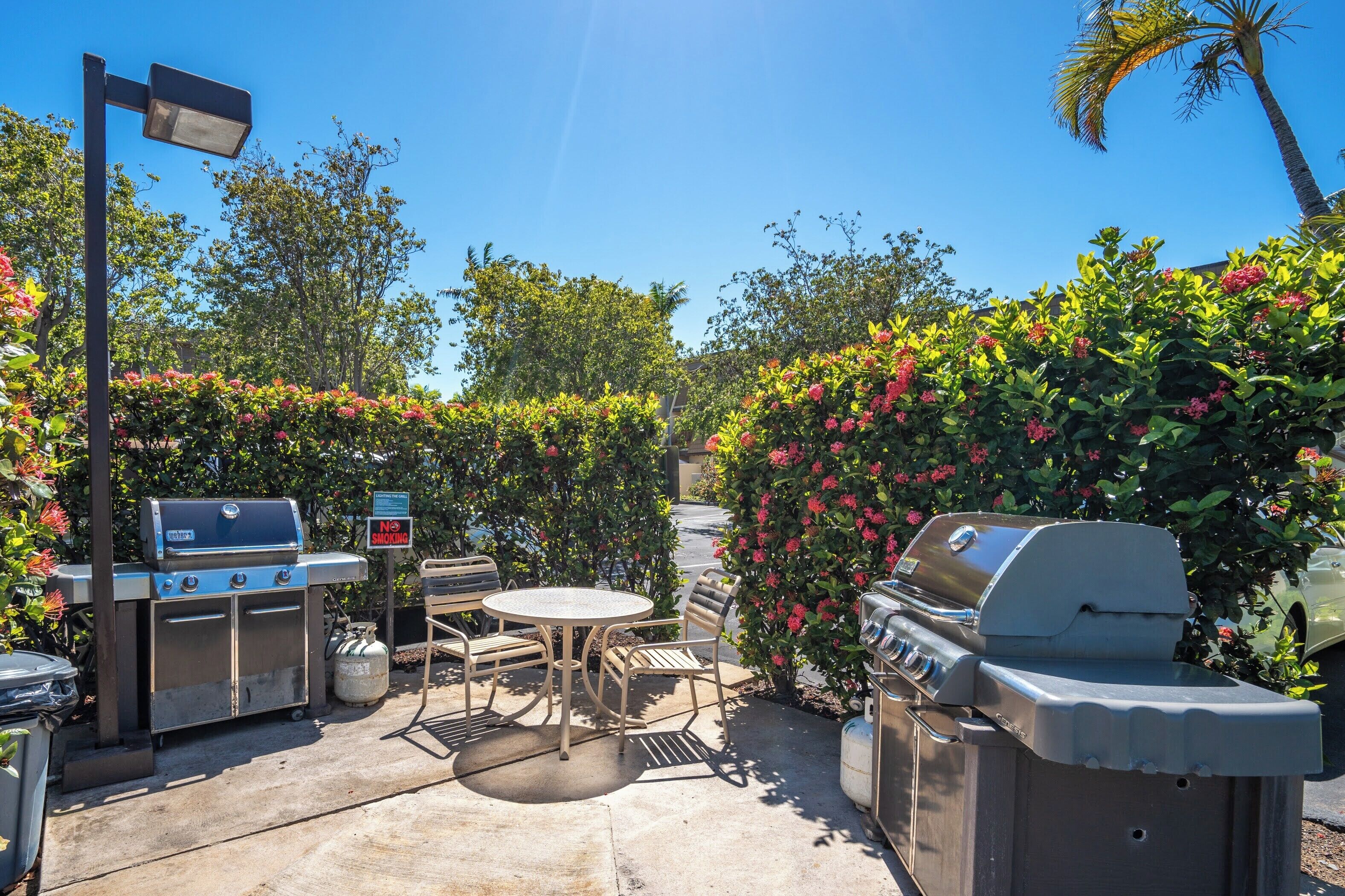 An outdoor patio with a grill, seating, and a 'No Smoking' sign.