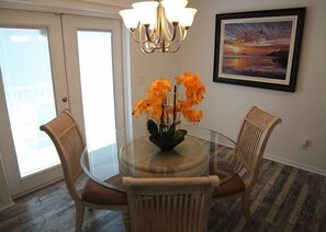 Enjoy meals in this dining area with a glass table and comfortable seating for four.